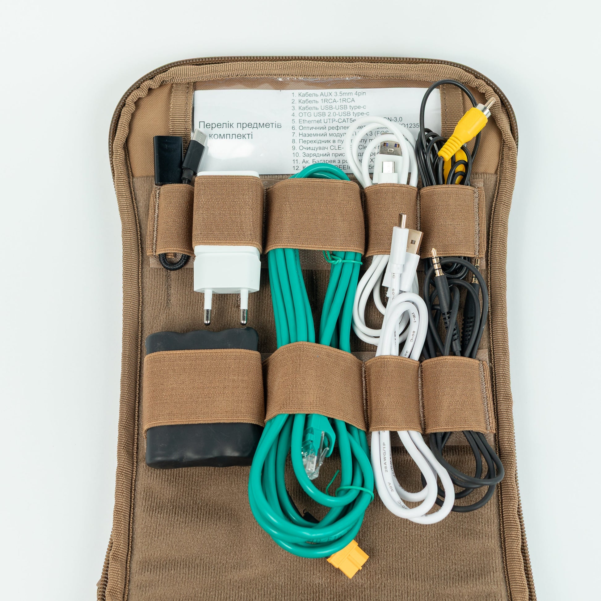 Brown organizer with electronic cables and chargers on a white background